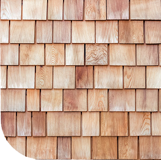 A weathered brick wall in black and white. The bricks are old and covered in grime.