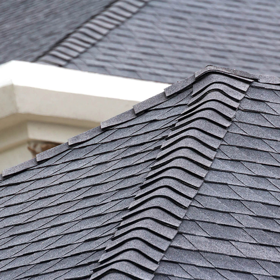 Dark gray roof shingles with a white trim. The shingles are layered and textured.