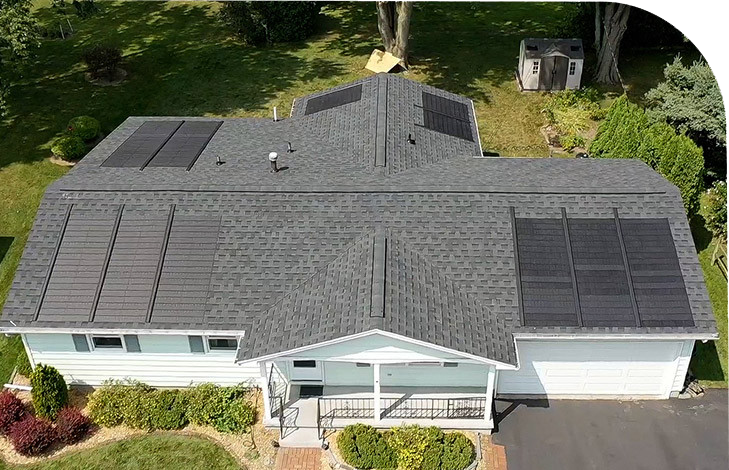 A large house with a big roof. The house has a yard.