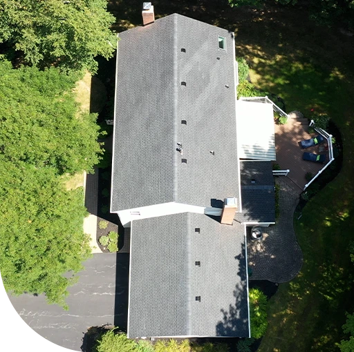 A gray aerial view of a large building and trees. The image appears to be a map or a satellite image.