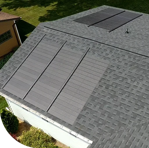 Black and white photo of a rooftop. The roof is made of bricks