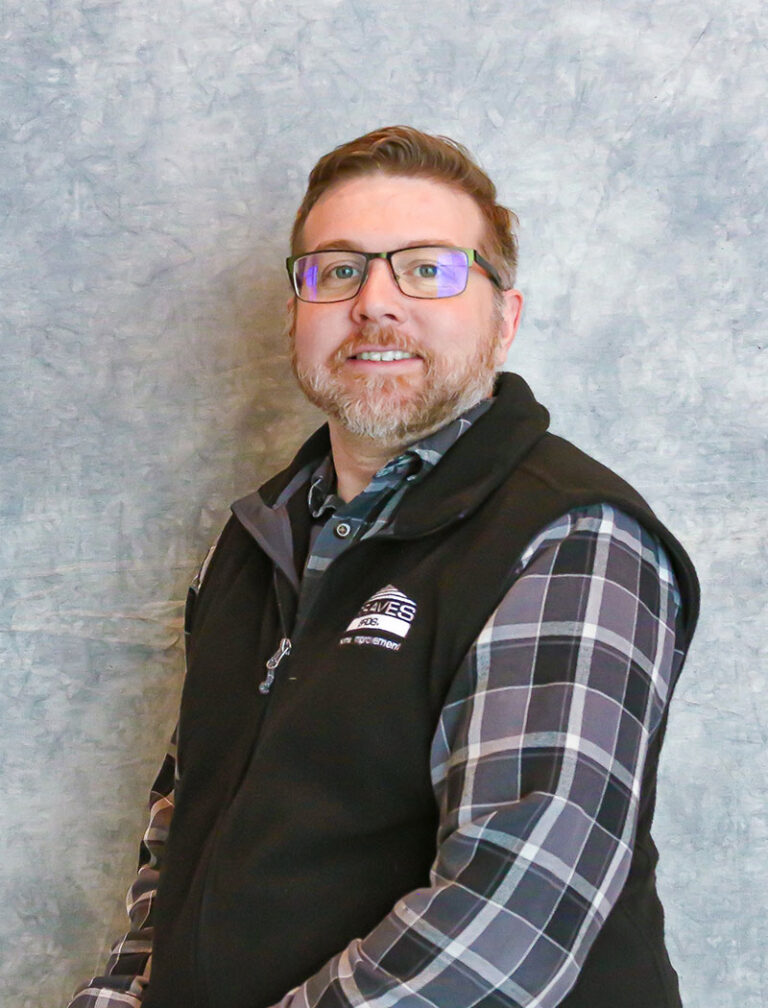 man wearing glasses and a black vest