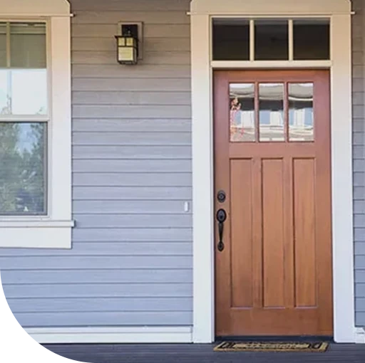 A weathered wooden door next to a shuttered window. The door and shutter appear old and worn.