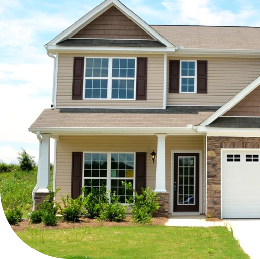 A two-story house with a brick and siding exterior. The house features a covered porch and a garage.