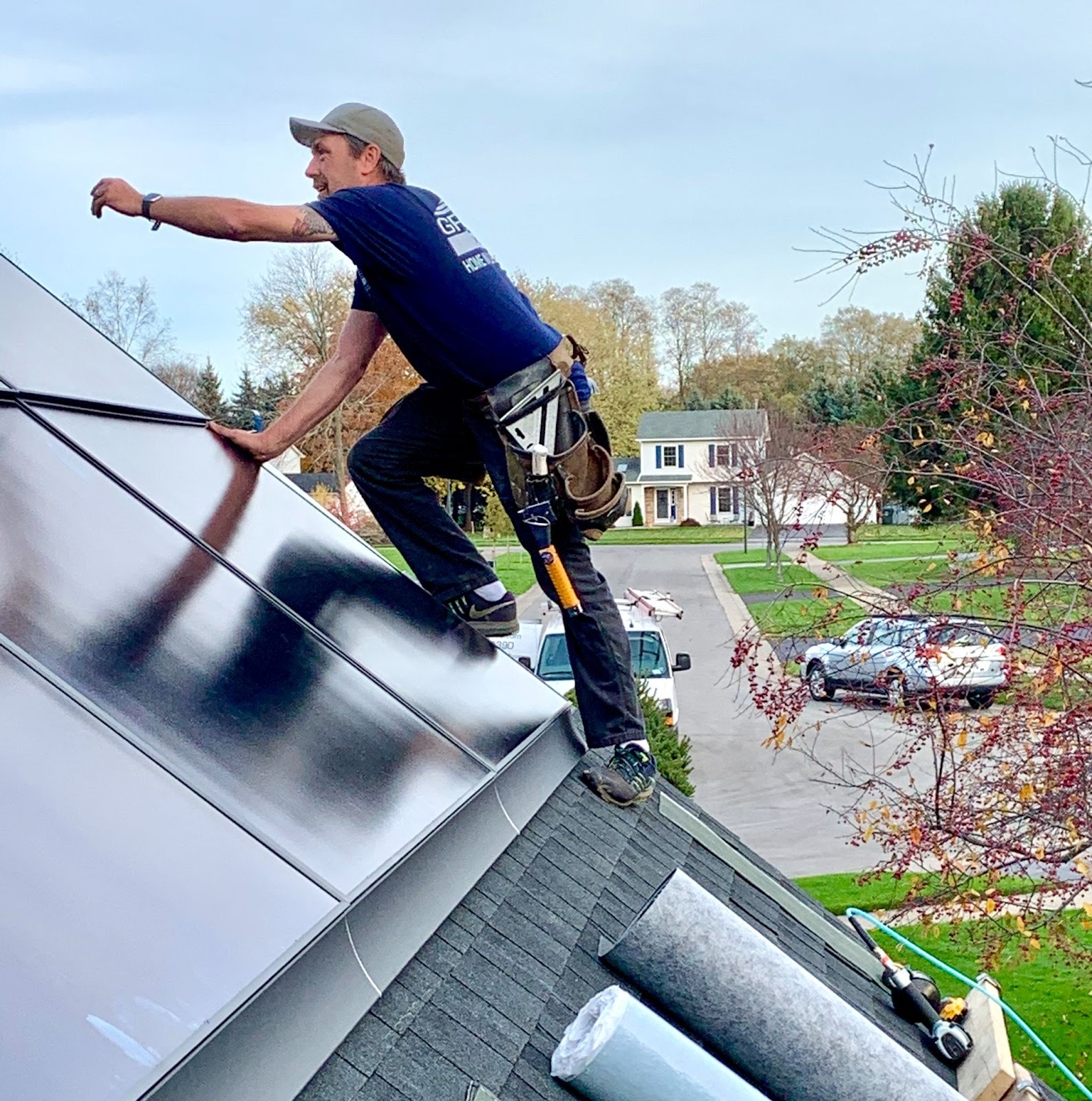 Man installing solar panels on a roof. Professional solar panel installation.
