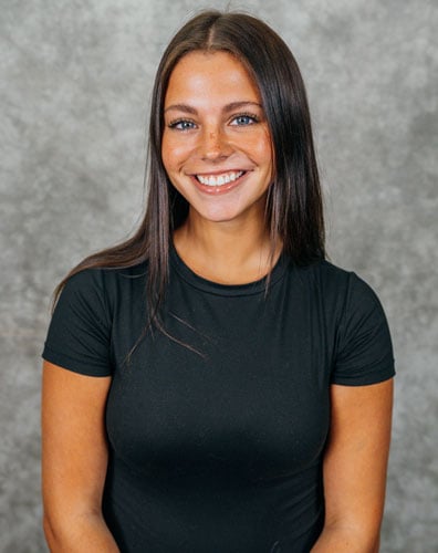 a woman with long dark hair smiling