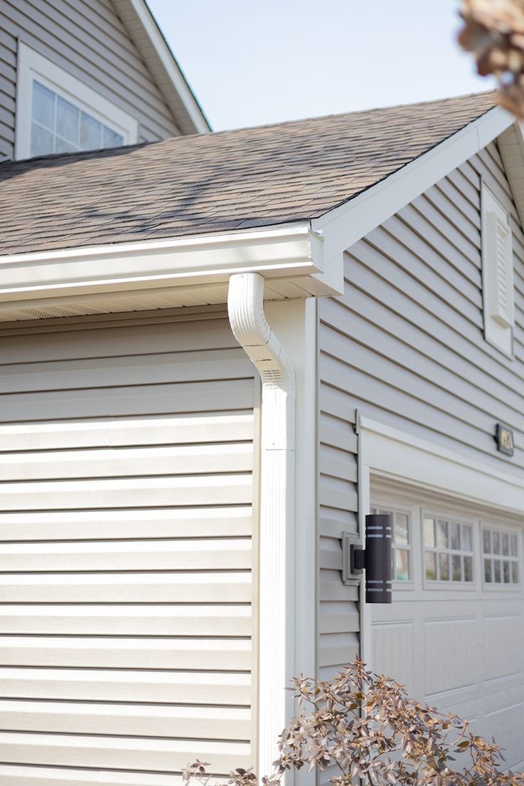 A house exterior with a gutter system and garage door.