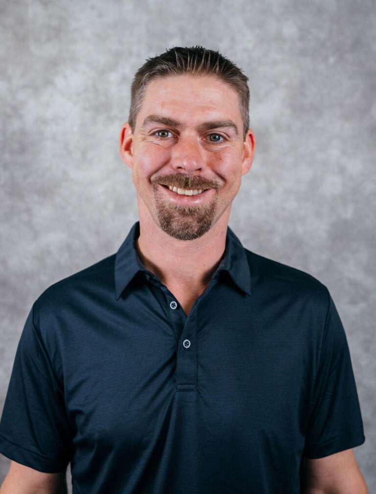 man smiling wearing dark blue polo