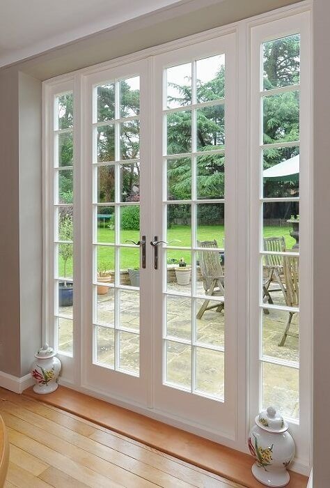 French doors with glass panels leading to outdoor patio