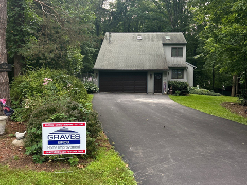 A residential home with a newly installed roof and a Graves Epic Home Improvement sign.