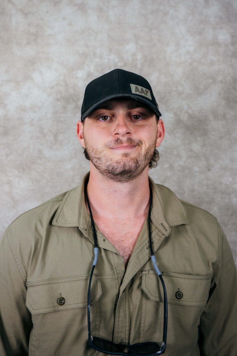Kashmeric fashion showcases male model in khaki shirt and cap.