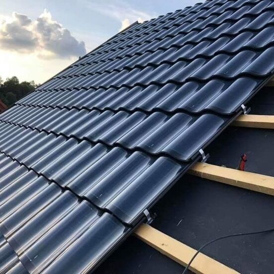 A roof with black tiles and wooden beams. The roof is under construction.