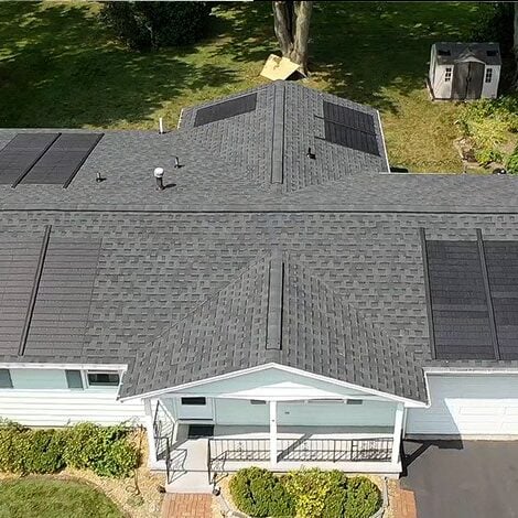 A large house with a big roof. The house has a yard.